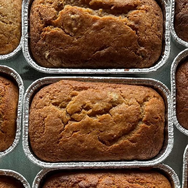 A loaf of banana bread in a foil pan, seen from above