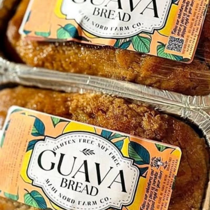 Loaves of guava bread in foil pans, each with a Maui Nord Farm Co. label