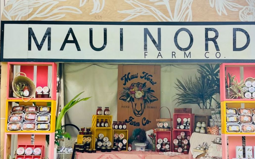 The Maui Nord Farm Co. sign above a fully stocked market booth